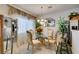 Elegant dining room featuring a glass-top table, decorative mirror, and natural light at 2050 Los Feliz St # 112, Las Vegas, NV 89156