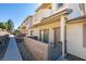 Stylish townhome featuring private patio with stone wall and well-maintained landscaping at 2050 Los Feliz St # 112, Las Vegas, NV 89156