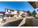 Condominium exterior featuring multiple levels, brick accent walls and desert landscaping at 2050 Los Feliz St # 112, Las Vegas, NV 89156