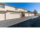 Exterior shot of multiple attached garages with a paved parking area on a bright day at 2050 Los Feliz St # 112, Las Vegas, NV 89156