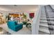 Inviting living room open to the kitchen with barstool seating and a staircase at 2050 Los Feliz St # 112, Las Vegas, NV 89156