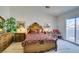 Bright bedroom with a decorative wood bed frame, balcony and an accent chair at 2050 Los Feliz St # 112, Las Vegas, NV 89156