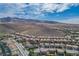 Scenic aerial view showcasing a sprawling community nestled amidst rolling hills and desert landscape at 2176 De Narvik Dr, Henderson, NV 89044