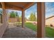 This covered back patio has stone columns and a view of the manicured backyard at 2176 De Narvik Dr, Henderson, NV 89044