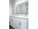 Modern bathroom featuring a double vanity, square mirror, and vanity lighting at 2176 De Narvik Dr, Henderson, NV 89044