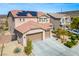 Stylish two-story home with three-car garage, modern landscaping, and solar panels for energy efficiency at 2176 De Narvik Dr, Henderson, NV 89044