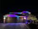 Festive two-story home adorned with colorful holiday lights at night at 2176 De Narvik Dr, Henderson, NV 89044