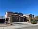 Two story home featuring a three car garage, long driveway and desert landscaping at 2176 De Narvik Dr, Henderson, NV 89044