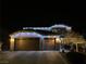 Festive two-story home adorned with colorful holiday lights at night at 2176 De Narvik Dr, Henderson, NV 89044