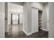 Hallway with wood floors, closet, and view to the adjacent living room with natural lighting at 2176 De Narvik Dr, Henderson, NV 89044