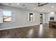 Living room with hardwood floors, plantation shutters, and an open layout leading to the kitchen at 2176 De Narvik Dr, Henderson, NV 89044