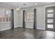 Well-lit living space featuring hardwood floors, neutral walls, and modern light fixtures at 2176 De Narvik Dr, Henderson, NV 89044