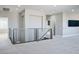 Open loft space with metal railing and access to other rooms and stairs at 2176 De Narvik Dr, Henderson, NV 89044