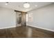 Bright main bedroom features wood floors, a barn door, a chandelier, and a window with shutters at 2176 De Narvik Dr, Henderson, NV 89044