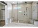 Luxurious walk-in shower with dual shower heads, bench seating, and decorative mosaic tile floor at 2176 De Narvik Dr, Henderson, NV 89044