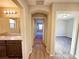 Hallway view showing bathroom and bedroom entrances with wood-look floors at 2241 Chandler Ranch Pl, Laughlin, NV 89029