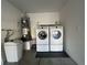 Efficient laundry area featuring a modern washer and dryer set with water heater at 2241 Chandler Ranch Pl, Laughlin, NV 89029