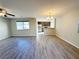 Open-concept space showcasing dark floors and a view into the kitchen at 2241 Chandler Ranch Pl, Laughlin, NV 89029