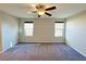 Spacious main bedroom featuring two windows and a ceiling fan at 2241 Chandler Ranch Pl, Laughlin, NV 89029