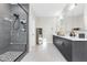 Contemporary bathroom featuring a glass-enclosed shower and double sink vanity at 2493 Verdello St, Henderson, NV 89044