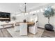 Open-concept dining area with modern chandelier, and a view into the living room at 2493 Verdello St, Henderson, NV 89044