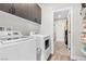 Well-equipped laundry room with modern appliances and ample storage shelves at 2493 Verdello St, Henderson, NV 89044