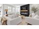 Bright living room featuring modern fireplace and large windows with wooden shutters providing lots of natural light at 2493 Verdello St, Henderson, NV 89044