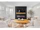 Bright living room with a modern fireplace feature and ample natural light at 2493 Verdello St, Henderson, NV 89044