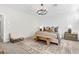 Comfortable main bedroom featuring a decorative rug, chandelier and a bench at the foot of the bed at 2493 Verdello St, Henderson, NV 89044