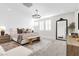 Bright main bedroom with a decorative chandelier, large mirror, and neutral color palette at 2493 Verdello St, Henderson, NV 89044