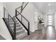 Carpeted staircase with modern railings leading to the home's front entrance and second floor at 2493 Verdello St, Henderson, NV 89044