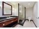 Modern bathroom featuring a granite vanity, frameless shower, and neutral tile flooring at 2700 Las Vegas Blvd # 1604, Las Vegas, NV 89109