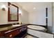 Bathroom with granite vanity and a soaking tub with marble tile surround at 2700 Las Vegas Blvd # 1604, Las Vegas, NV 89109