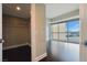 Bedroom with walk-in closet shows window with city views and hardwood floors at 2700 Las Vegas Blvd # 1604, Las Vegas, NV 89109