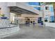 The building entrance features a roundabout driveway, modern architecture and desert landscaping at 2700 Las Vegas Blvd # 1604, Las Vegas, NV 89109