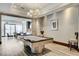This recreation room features a billiards table and lounge area that are illuminated by a modern chandelier at 2700 Las Vegas Blvd # 1604, Las Vegas, NV 89109