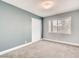 Neutral bedroom featuring a large window, closet, and plush carpeting at 2712 Royal St, North Las Vegas, NV 89030