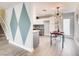 Dining area featuring hardwood floors, modern lighting, and a view into the kitchen at 2712 Royal St, North Las Vegas, NV 89030