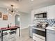 Modern kitchen features stainless steel appliances, hexagon backsplash, and a dining area with unique lighting at 2712 Royal St, North Las Vegas, NV 89030