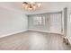 Bright living room with neutral paint, hardwood floors, and modern lighting at 2712 Royal St, North Las Vegas, NV 89030