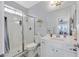 Bright bathroom featuring a glass-enclosed shower, white vanity, and modern fixtures at 3037 Villanelle Ave, Henderson, NV 89044