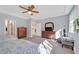 Cozy bedroom featuring two beds, a dresser with television and a ceiling fan at 3037 Villanelle Ave, Henderson, NV 89044