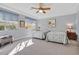 Bright bedroom featuring two beds, soft gray walls, and a ceiling fan for added comfort at 3037 Villanelle Ave, Henderson, NV 89044