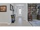 Inviting entryway with tiled floor leading to a study with custom built-in bookshelves and cabinets at 3037 Villanelle Ave, Henderson, NV 89044