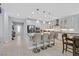 Bright kitchen features modern stainless steel appliances, a center island with seating and white cabinetry at 3037 Villanelle Ave, Henderson, NV 89044