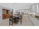 Spacious open-concept kitchen with white cabinetry, pendant lighting, stainless steel appliances and dining area at 3037 Villanelle Ave, Henderson, NV 89044