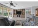 This living room features a ceiling fan, backyard access, comfortable seating and custom built-in cabinetry at 3037 Villanelle Ave, Henderson, NV 89044