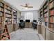 Home office featuring custom built-in bookshelves, dual desks, and ample storage at 3037 Villanelle Ave, Henderson, NV 89044