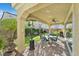 Covered patio area with outdoor seating, a ceiling fan, and views of a well-maintained garden at 3037 Villanelle Ave, Henderson, NV 89044