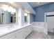 Modern bathroom featuring double sinks, white cabinets, a large mirror, and a separate tub and shower at 3109 Bangor Ct, Las Vegas, NV 89134